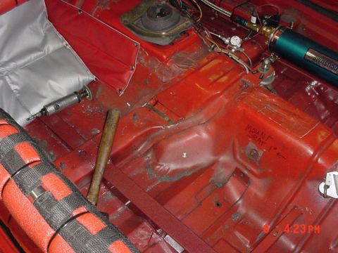 1993 Ford Mustang - Interior floor of a car undergoing modification, with tools and aftermarket parts visible.