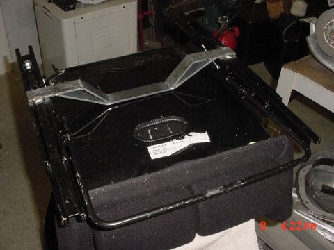 1993 Ford Mustang - A close-up view of a vehicle seat base, showing its internal structure and fabric upholstery.