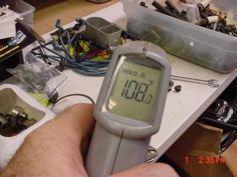 1993 Ford Mustang - A digital thermometer displays 108.0 degrees Fahrenheit amidst a collection of automotive parts and tools.