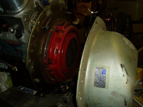 1978 Ford F-250 - Close-up view of an engine's clutch assembly and a detached metal shield.