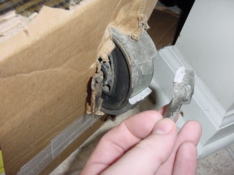 1984 BMW 3 Series - A damaged rubber and metal component is held in hand after being removed from its cardboard packaging.