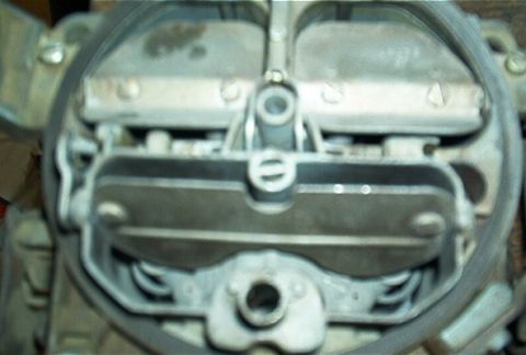 1986 Ford Bronco - Close-up view of a carburetor, a critical engine component.