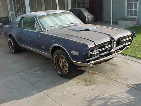 1968 Mercury Cougar - This blue Mercury Cougar has a distinctive grille and hood scoop, typical of the late 1960s models.