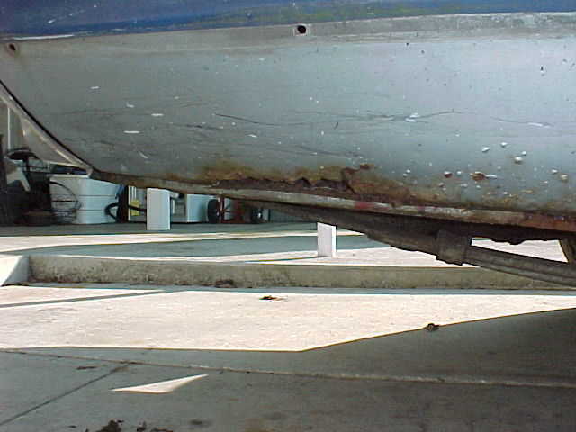 Rust holes in the lower rear quarter. John Hudson replaced this section with a piece cut from a perfect original quarter panel including the trunk floor drop off.