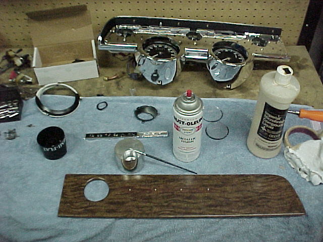 The rechromed and detailed instrument bezel looks great. I painted the back ground areas on the dash emblems. The wood grain dash parts are the original ones and were carefully stained and then waxed to make them appear new again.