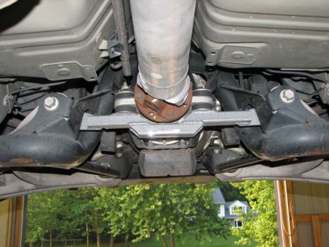 2001 Mercury Grand Marquis - Underside view of a vehicle's rear axle, driveshaft, and exhaust pipe with Supermotors.net logo.