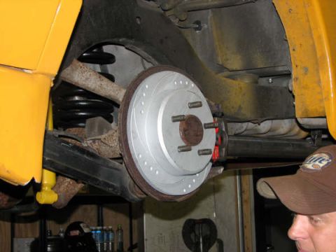 2001 Mercury Grand Marquis - Close-up view of a vehicle's rear brake rotor and suspension system.