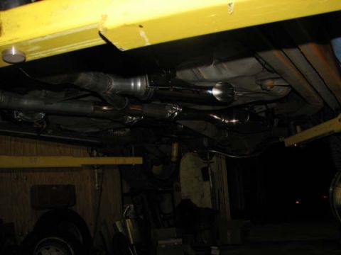 2001 Mercury Grand Marquis - The exhaust system and undercarriage of a 2001 Mercury Grand Marquis are visible, mounted on a lift.