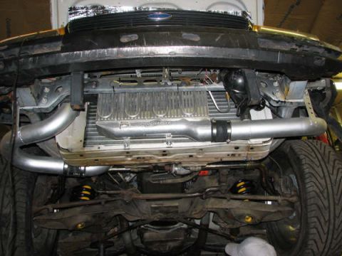 2001 Mercury Grand Marquis - Undercarriage view shows an aftermarket intercooler and custom exhaust piping installed on the vehicle.