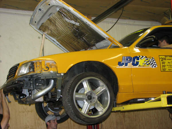 2001 Mercury Grand Marquis taxi on lift, hood open, front bumper removed