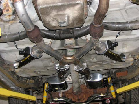 2001 Mercury Grand Marquis - The exhaust system of a vehicle is shown from underneath, including dual mufflers and chrome tips.