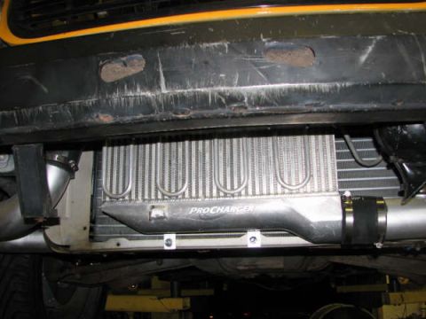 2001 Mercury Grand Marquis - Underside view of a ProCharger intercooler, with visible text and mounting hardware.