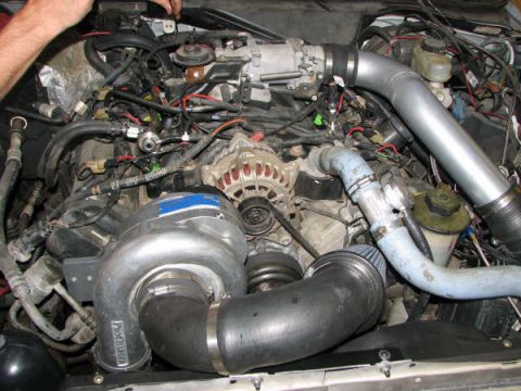2001 Mercury Grand Marquis - Close-up view of a modified engine bay, highlighting a supercharger and various engine components.