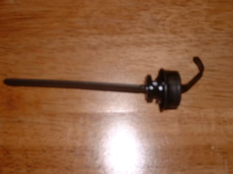 1978 Ford Mustang II - An oil dipstick is shown against a wooden background.