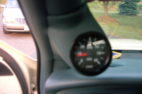 1996 Mercury Grand Marquis - A gauge pod is installed in the interior of a vehicle, with another car visible outside.