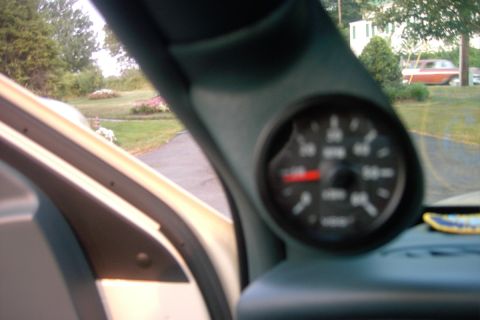 1996 Mercury Grand Marquis - A VDO tachometer is installed in a gauge pod on the A-pillar, with a red needle indicating RPM.