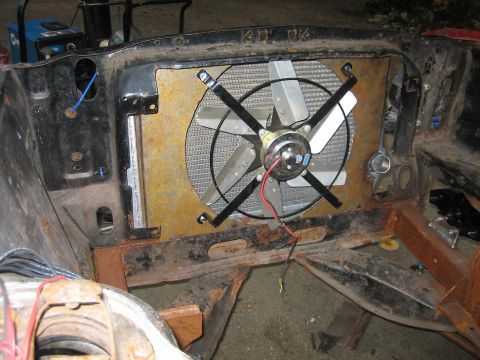 1969 Ford Mustang - Close-up of a car's radiator and fan assembly, showing rust and wiring.