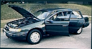 1994 Ford Taurus - 1994 Ford Taurus station wagon with hood and doors open, showing the engine bay and interior.