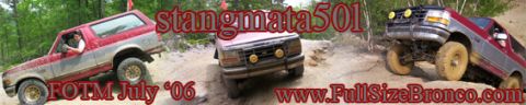 1996 Ford Bronco - Multiple Ford Broncos navigate an off-road trail with steep inclines and loose dirt.
