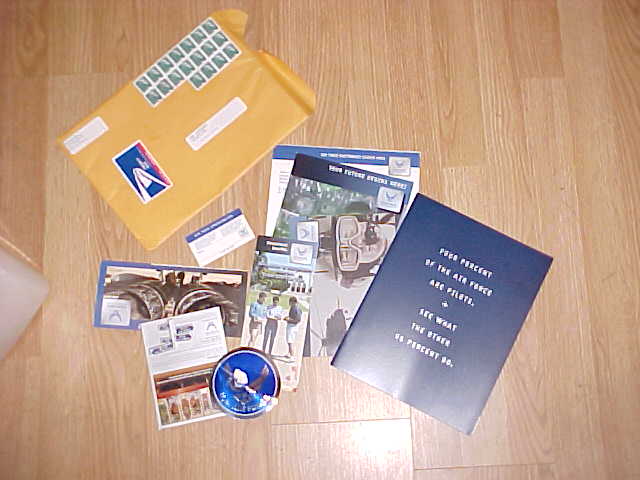 Air Force recruiting mailer contents spread on floor: envelope, brochures, blue folder, CD