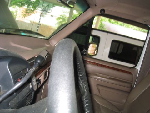 1996 Ford Bronco - Interior view of a 1996 Ford Bronco, with a glimpse of another vehicle outside.