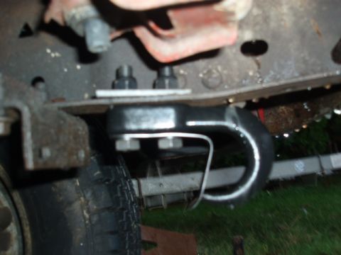 1985 Ford Bronco II - Close-up view of a vehicle's tow hitch assembly and a portion of a tire.
