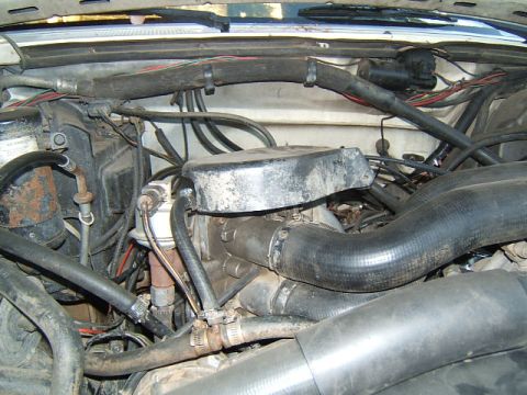 1988 Ford Bronco - Close-up view of a vehicle's engine bay, showing various components and wiring.