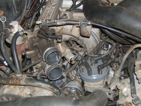 1988 Ford Bronco - Engine bay detail throttle body and distributor cap with spark plug wires.