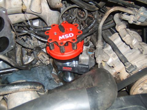 1988 Ford Bronco - Close-up view of engine components, including a red MSD ignition distributor cap and associated wiring.