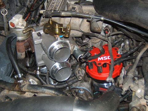 1988 Ford Bronco - Installation of a dual throttle body and MSD ignition distributor in an engine bay.
