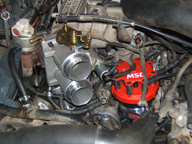 Engine bay with dual throttle body and red MSD ignition distributor
