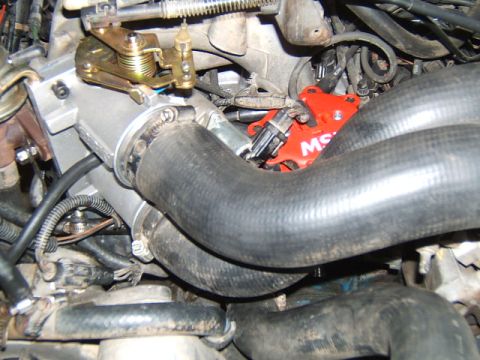 1988 Ford Bronco - Engine bay components including throttle body and MSD ignition are visible in this close-up shot.