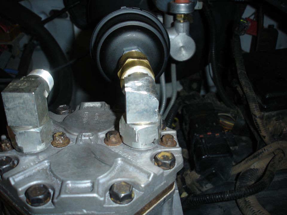 Engine part with metal fittings and a black filter housing