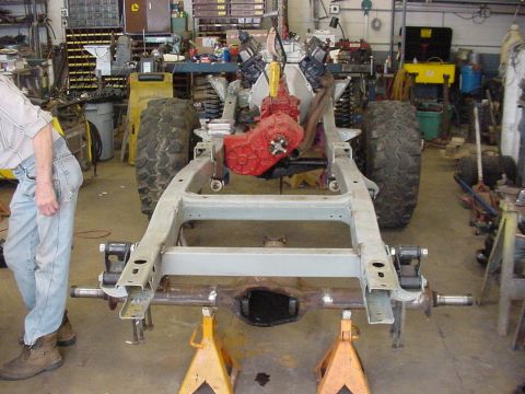 1969 Ford Bronco - Vehicle frame and powertrain assembly in a workshop setting.