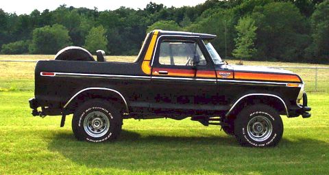 1979 Ford Bronco - This 1979 Ford Bronco features a distinctive stripe package and a spare tire mounted on the rear.