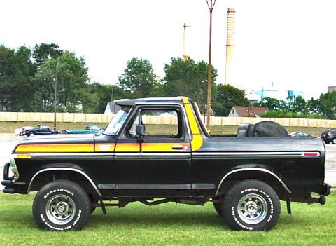 1979 Ford Bronco - This black 1978 Ford Bronco features distinctive yellow and orange racing stripes along its side.
