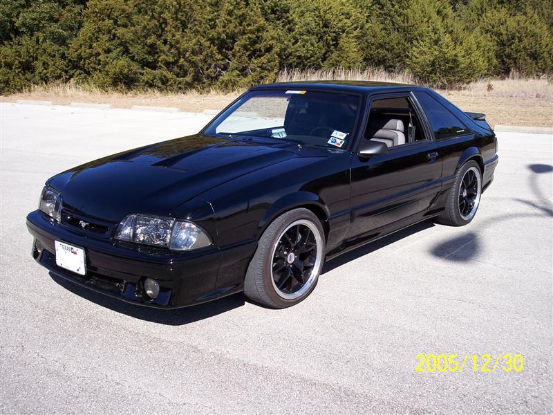 Black coupe with aftermarket wheels, 1993 model year