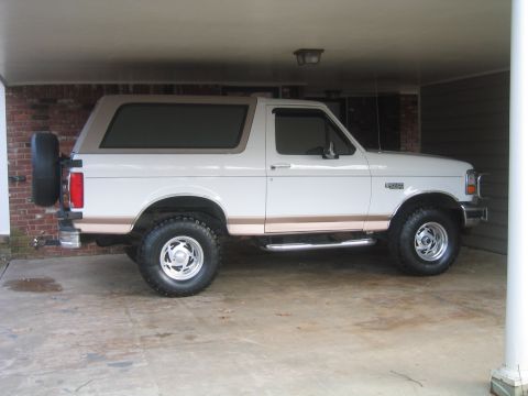 1996 Ford Bronco - This 1996 Ford Bronco is shown from the side, parked under a covered area with a spare tire mounted on the rear.