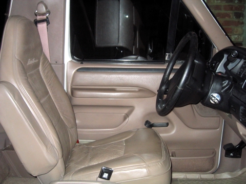 1996 Ford Bronco - Interior view of a 1996 Ford Bronco, highlighting the tan leather seats and dashboard components.