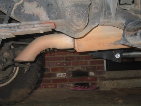 1996 Ford Bronco - Close-up view of the undercarriage, focusing on the exhaust system and suspension parts.