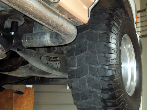 1996 Ford Bronco - Undercarriage view of a vehicle, focusing on the tire and suspension system.