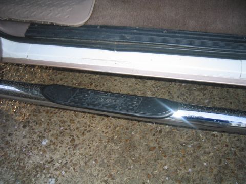 1996 Ford Bronco - The running board has a textured step pad for grip, mounted on a chrome bar.