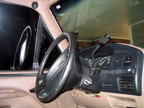 1996 Ford Bronco - The interior of a 1992 Ford Bronco shows a tan dashboard and black steering wheel.
