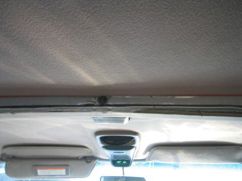 1996 Ford Bronco - The overhead console and sun visors are visible inside the vehicle's cabin.