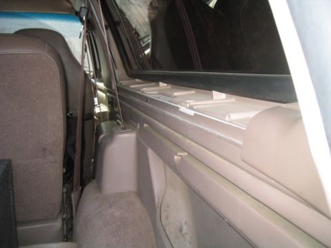 1996 Ford Bronco - Interior view of a vehicle, focusing on the rear seating area and side trim.