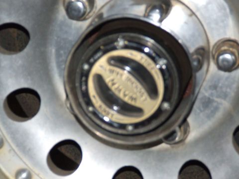 1986 Ford Bronco - A close-up view of a vehicle's hubcap, displaying a "WARNER" logo, is shown.