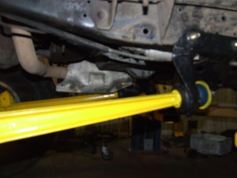 1986 Ford Bronco - Undercarriage view showing yellow suspension parts and exhaust system.