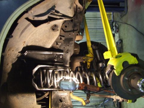 1986 Ford Bronco - Front suspension components, including a coil spring and brake assembly, are visible.