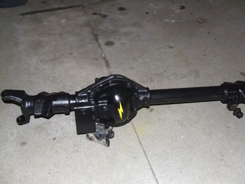 1986 Ford Bronco - A black Dana 44 axle assembly is shown with a yellow lightning bolt sticker on the differential cover.