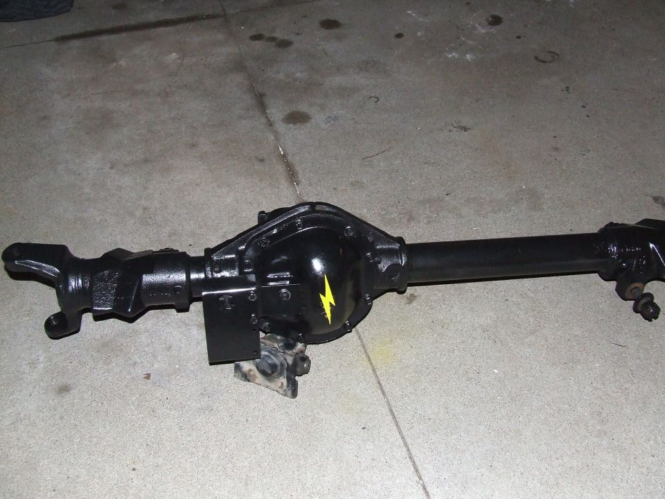Black Dana 44 axle assembly with yellow lightning bolt sticker on differential cover